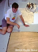 JJohn screws a temporary hatch cover onto the deck of aluminum expedition sailboat Morgan's Cloud during the refit