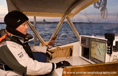 Phyllis navigates using a computer-based electronic charting program at the cockpit chart table on aluminum expedition sailboat Morgan's Cloud