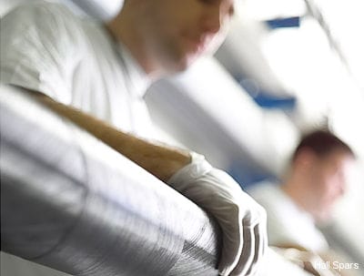 Hall Spars technicians wrap carbon fibre on a spinnaker pole