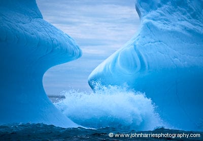 An iceberg is formed by waves on the southeast coast of Greenland