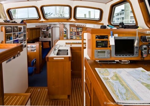 "Polaris" has a huge open and airy raised salon, but note that the layout is carefully designed so there are no dangerous wide open areas to be thrown across at sea; something so common on production boats. The master cabin is forward and a tiny guest cabin with bunk beds to starboard. (Michael and Martina agree with Phyllis and I that guest cabins should never be too comfortable; that way guests don't stay too long!) This is a boat intelligently designed for two with occasional guests; no rabbit warren of three cabins and eight-plus berths that a production boat of this size would be cursed with. The single head is aft where it is easily accessible from the cockpit.