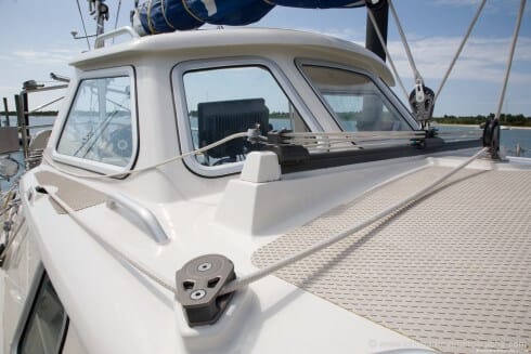 A view from forward of the hard dodger. Note the mounting plate under the block in the foreground. On "Polaris", like "Morgan's Cloud", the deck fittings are mounted on threaded plates that are welded to the deck so the fastenings do not penetrate through to the underside and there is no possibility of leaks.