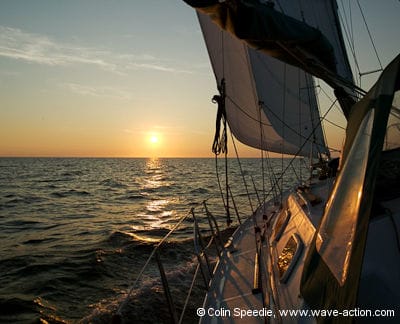 Ovni under sail at sunset