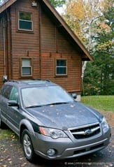 Car in front of cottage in fall JHHGH1-1020465
