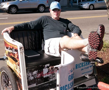Bicycle rickshaw driver taking a break, Charleston, SC JHHGH1-1050340