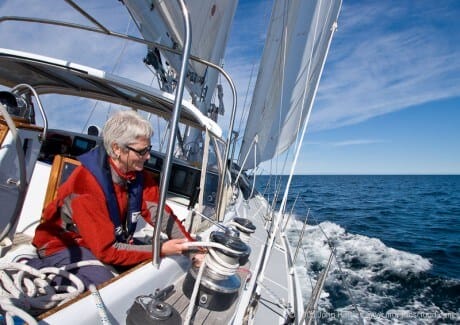 Phyllis trims the jib while sailing to windward on a sunny day on Morgan's Cloud