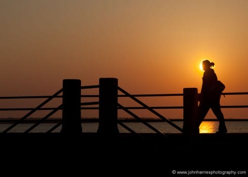 The key to this shot was anticipation. I carefully composed with the sun off center and the strong diagonal lines of the rails to the left just included. I then dialed in 2-1/2 of negative exposure compensation to make the walker a silhouette. I took a test shot to make sure I had it right and then waited. As the person walked into the frame, I fired a burst of seven frames and got this one as number three. You do need a camera that is quite responsive and has a high frame rate for this kind of thing. Also be careful not to stare into the sun or expose the camera sensor to it for too long.