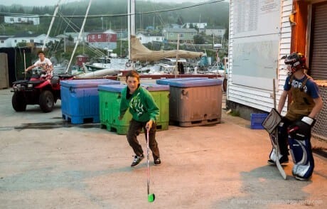 Young boys playing wharf hockey in LaPoile, Newfoundland