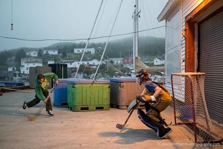 Kids playing hockey on a wharf in La Poile, Newfoundland JHHG3-1000661