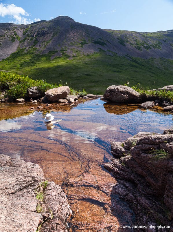 Woman bathing in small pond, La Hune Bay, Newfoundland