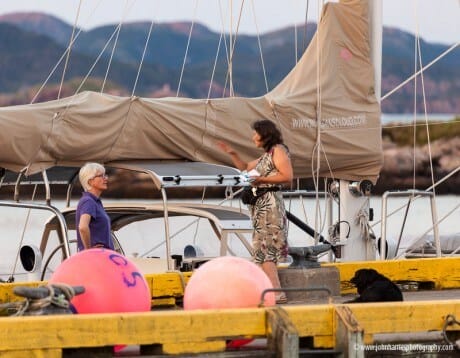 Phyllis and June talk on the dock at Burgeo with Morgan's Cloud tied up behind them