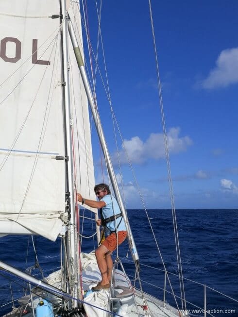 Lowering the pole onto the foredeck to be rigged.